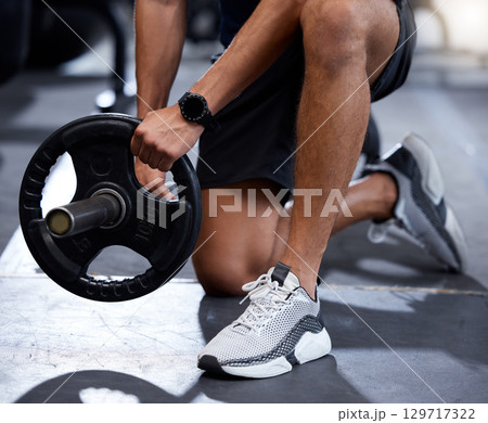 Fitness, gym or hands training with a barbell or heavy equipment for muscle growth or development workout. Shoes, bodybuilder or healthy strong man starting weightlifting strength training exercise Fitness, gym or hands training with a barbell or heavy equipment for muscle growth or development workout. Shoes, bodybuilder or healthy strong man starting weightlifting strength training exercise 129717322
