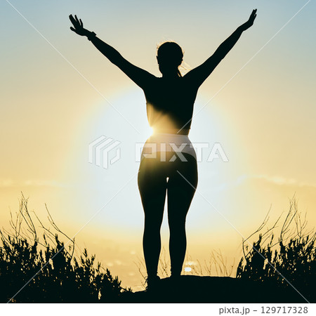 Motivation, nature and silhouette of woman at sunrise enjoying morning, peace and freedom by ocean. Inspiration, calm and back of girl with arms raised for spiritual worship, wellness and meditation Motivation, nature and silhouette of woman at sunrise enjoying morning, peace and freedom by ocean. Inspiration, calm and back of girl with arms raised for spiritual worship, wellness and meditation 129717328