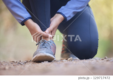 Running, ankle pain and injury with shoes of black woman on nature trail for training, jogging and endurance. Sprain, accident and broken with girl runner on path for workout, exercise and sports 129717472