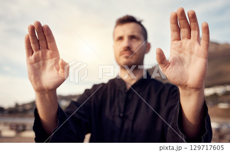 Karate, martial arts and hands of man doing tai chi workout, balance training and sports exercise. Motivation, fitness and male athlete with focus for mindfulness, wellness and zen energy by sea Karate, martial arts and hands of man doing tai chi workout, balance training and sports exercise. Motivation, fitness and male athlete with focus for mindfulness, wellness and zen energy by sea 129717605