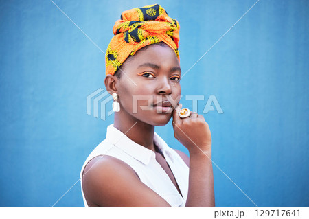 Portrait, black woman and turban with makeup or relax on blue studio background. Nigerian female, girl or lady with traditional head wrap, natural beauty or cosmetics for smooth, clear skin or mockup Portrait, black woman and turban with makeup or relax on blue studio background. Nigerian female, girl or lady with traditional head wrap, natural beauty or cosmetics for smooth, clear skin or mockup 129717641