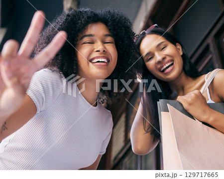 Friends, happy shopping and peace sign portrait in city for retail therapy freedom, quality time and customer happiness. Luxury usa store, shopping bag and black women smile for fashion promotion Friends, happy shopping and peace sign portrait in city for retail therapy freedom, quality time and customer happiness. Luxury usa store, shopping bag and black women smile for fashion promotion 129717665