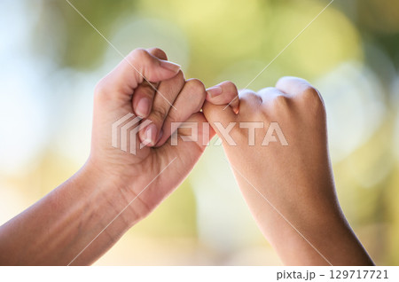 People, promise and fingers for support, trust and love connection in nature outdoors. Closeup, hands and couple of friends link little finger for hope, respect and commitment, kindness and agreement 129717721