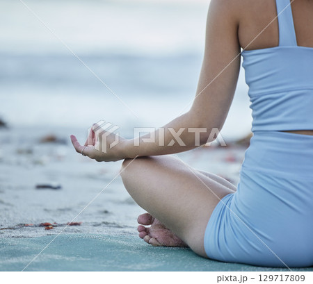 Yoga, back view or woman in meditation at a beach in a zen lotus pose training for mindfulness or holistic spiritual energy. Nature, fitness or healthy girl hands by a calm, peaceful or relaxing sea Yoga, back view or woman in meditation at a beach in a zen lotus pose training for mindfulness or holistic spiritual energy. Nature, fitness or healthy girl hands by a calm, peaceful or relaxing sea 129717809