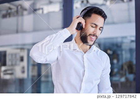 Business man, headphones and listening to music in office for motivation, inspiration or freedom on break. Happy young worker listen to audio, radio or podcast for happiness, smile and fun in startup Business man, headphones and listening to music in office for motivation, inspiration or freedom on break. Happy young worker listen to audio, radio or podcast for happiness, smile and fun in startup 129717842