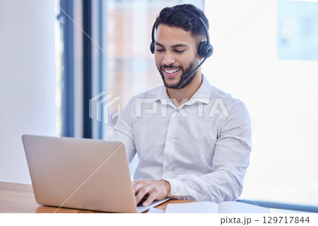 Man, customer service and telemarketing call center agent using laptop and headset in the office. Contact us, sales and help desk job, smile and working to tell you about us in crm business workplace Man, customer service and telemarketing call center agent using laptop and headset in the office. Contact us, sales and help desk job, smile and working to tell you about us in crm business workplace 129717844