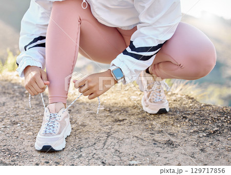 Shoe, hand and woman tie lace for fitness, sport and run in nature for exercise and training workout. Athletic, athlete and footwear of a female sports runner prepare for running marathon outside Shoe, hand and woman tie lace for fitness, sport and run in nature for exercise and training workout. Athletic, athlete and footwear of a female sports runner prepare for running marathon outside 129717856