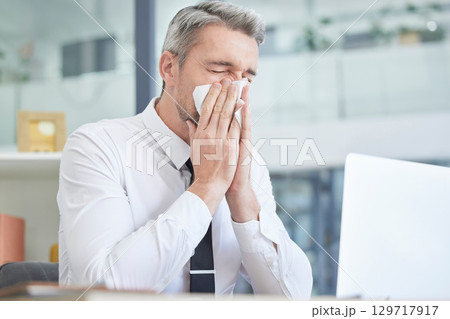 Allergies, sick and businessman in his office cleaning nose with healthcare risk, workplace compliance policy and management stress. Dust, bacteria and allergy of business or corporate man at a desk Allergies, sick and businessman in his office cleaning nose with healthcare risk, workplace compliance policy and management stress. Dust, bacteria and allergy of business or corporate man at a desk 129717917