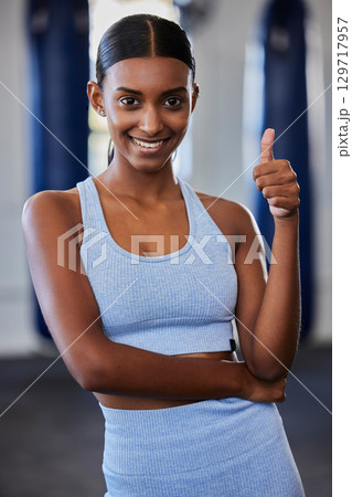 Thumbs up, Indian woman and fitness, wellness and exercise health model with positive energy in gym. Motivation, encouragement and support for happy training workout, sports athlete and healthy goal Thumbs up, Indian woman and fitness, wellness and exercise health model with positive energy in gym. Motivation, encouragement and support for happy training workout, sports athlete and healthy goal 129717957