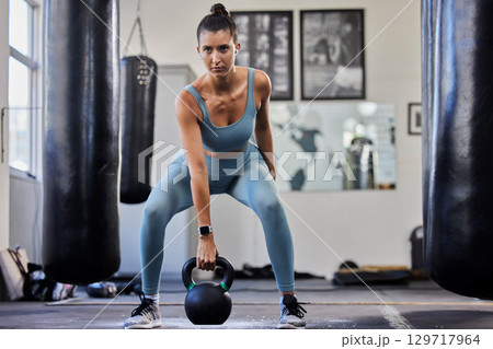 Gym woman, weightlifting kettlebell and focus for fitness, health and training in crossfit studio. Bodybuilder girl, muscle exercise and strong arms with goal, vision and determination for wellness 129717964