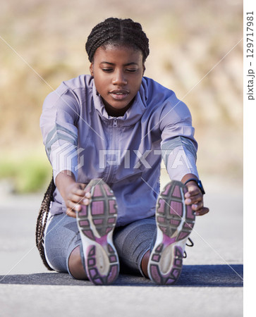 Exercise, black woman and stretching outdoor for wellness, health and fitness. Nigerian female, healthy lady and athlete training, workout and sports for power, practice or cardio for energy or relax 129717981