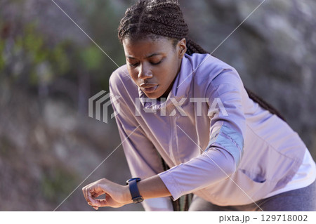 Black woman runner, smartwatch and rest for breathing, heart rate or health while training in summer. Woman, running and healthcare tech for exercise, workout and fitness at nature park in California 129718002