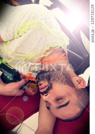 Party, drunk and alcohol with a man sleeping on the floor after a new year celebration or event closeup. Beer, social and tired with a male asleep in a house or home with a bottle after a birthday Party, drunk and alcohol with a man sleeping on the floor after a new year celebration or event closeup. Beer, social and tired with a male asleep in a house or home with a bottle after a birthday 129718129