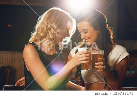 Women friends, toast beer and club with happiness, smile and celebration for new year with bonding. Woman, nightclub party and happy with alcohol glass, happy hour drinks or glass for festive cheers Women friends, toast beer and club with happiness, smile and celebration for new year with bonding. Woman, nightclub party and happy with alcohol glass, happy hour drinks or glass for festive cheers 129718179