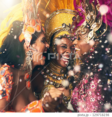 Women, laughing or samba carnival dancers in Brazilian in celebration event, street night party or city performance. Dancing festival, feathers or fashion costume for smile, happy or bonding friends 129718236