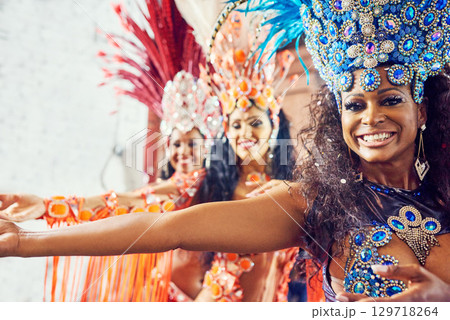 Brazil, dance and carnival with a woman group at a festival during a performance of tradition, culture or heritage. Portrait, event and celebration with female dancers dancing in rio de janeiro Brazil, dance and carnival with a woman group at a festival during a performance of tradition, culture or heritage. Portrait, event and celebration with female dancers dancing in rio de janeiro 129718264