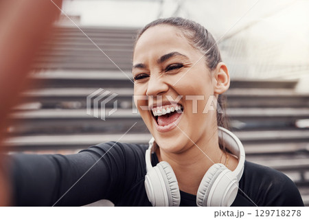 Woman, face and selfie with headphones and exercise in city, happy in Brazil, laughter and fitness outdoor. Runner, cardio and happiness in picture, health and wellness with active lifestyle 129718278
