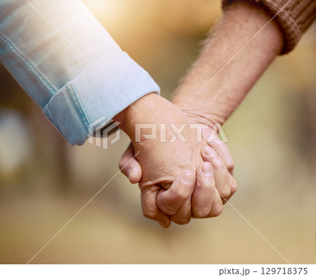Senior couple, holding hands and walking in nature to bond in the countryside for love, care and affection. Retirement, hands of elderly husband and wife together in a loving, caring relationship Senior couple, holding hands and walking in nature to bond in the countryside for love, care and affection. Retirement, hands of elderly husband and wife together in a loving, caring relationship 129718375