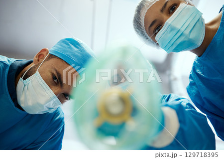Health, surgeon and anesthesia, doctors and surgery with medical and cardiovascular healthcare, face mask and low angle view. Medicine, operation and health care team, cardiology and hospital. 129718395