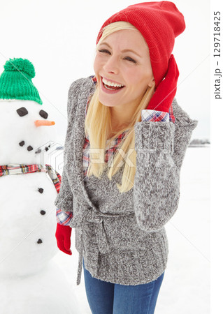 Christmas, woman and snowman outdoor in winter, happy smile and cold in Austria during festive holiday or season. Young female, happiness and fun outside in nature, smiling and laugh with portrait Christmas, woman and snowman outdoor in winter, happy smile and cold in Austria during festive holiday or season. Young female, happiness and fun outside in nature, smiling and laugh with portrait 129718425