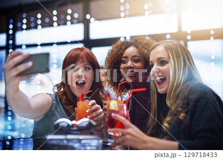 Women, friends and phone selfie at club with drinks, having fun or bonding. Night, celebration and group of girls taking a photo on mobile smartphone for happy memory, social media or profile picture 129718433