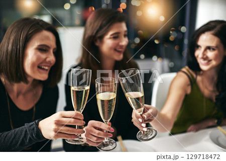Celebration, friends and dinner toast at restaurant for togetherness, happiness and wellness with smile. Alcohol, dining and cheers of women drinking together to celebrate happy friendship. Celebration, friends and dinner toast at restaurant for togetherness, happiness and wellness with smile. Alcohol, dining and cheers of women drinking together to celebrate happy friendship. 129718472
