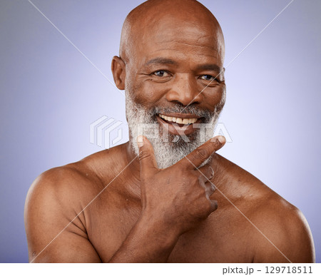 Portrait, black man and facial skincare in studio for personal hygiene, clean face and natural cosmetics on grey background. Happy guy, mature male beauty and wellness spa for body care in Nigeria 129718511