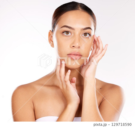 Portrait, face and skincare with a model black woman in studio on a gray background for wellness or luxury. Makeup, cosmetics and hands with an attractive young female touching her natural skin Portrait, face and skincare with a model black woman in studio on a gray background for wellness or luxury. Makeup, cosmetics and hands with an attractive young female touching her natural skin 129718590