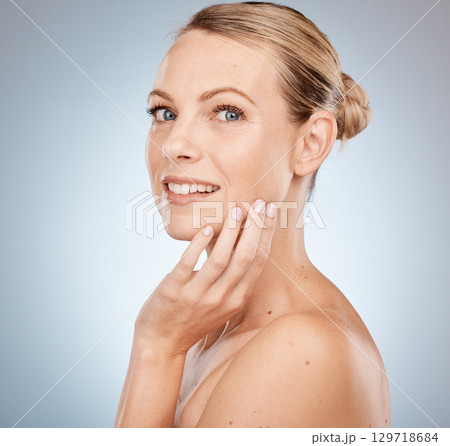 Beauty, wellness and portrait of a woman in studio with health, cosmetic and natural skincare routine. Makeup, face and model from Australia with skin or facial treatment isolated by gray background. Beauty, wellness and portrait of a woman in studio with health, cosmetic and natural skincare routine. Makeup, face and model from Australia with skin or facial treatment isolated by gray background. 129718684