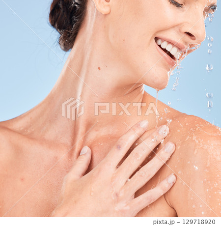 Woman, skincare and happy in shower for beauty wellness, body hygiene and salon spa cleaning. Model, smile and luxury cosmetics care and natural dermatology with water in blue background studio 129718920