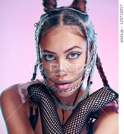 Model, bdsm and grunge fashion with makeup, jewelry and chains, goth aesthetic and punk rock clothes on studio background. Face, portrait and gen z girl with mask, cosmetics and halloween cosplay 129718957