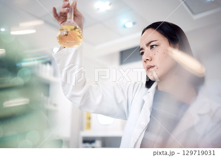Scientist, medical research and thinking while holding chemical in beaker for analytics, solution and virus test in science laboratory. Asian woman doctor with medicine for healthcare and chemistry Scientist, medical research and thinking while holding chemical in beaker for analytics, solution and virus test in science laboratory. Asian woman doctor with medicine for healthcare and chemistry 129719031