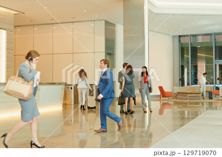 Business people, walking and an airport terminal for travel, global trade and success. Working, group and workers take steps though lobby with communication, check in and catch international flights. Business people, walking and an airport terminal for travel, global trade and success. Working, group and workers take steps though lobby with communication, check in and catch international flights. 129719070