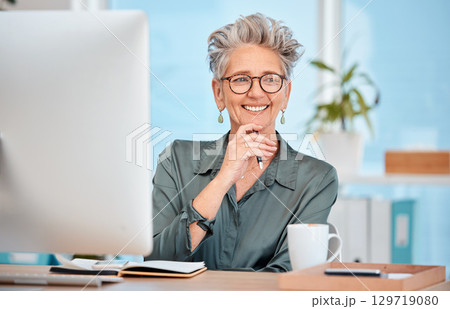 Computer, office and senior business woman doing online research or planning a corporate project. Technology, professional and elderly female manager working on a management report in her workplace. 129719080