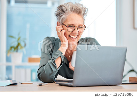 Laptop, coffee and senior business woman laughing at an email in her office at work for fun or humor. Computer, tea and comic with a mature female employee working on a report or project and joking Laptop, coffee and senior business woman laughing at an email in her office at work for fun or humor. Computer, tea and comic with a mature female employee working on a report or project and joking 129719096