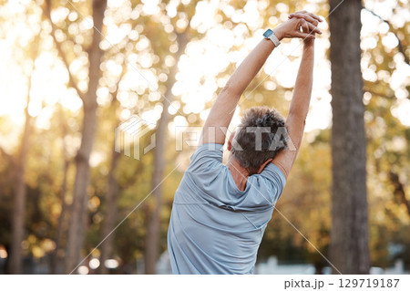 Stretching, fitness and man in park for muscle and body workout, wellness and health in nature with mental health, calm and peace. Exercise, training and sports athlete warm up for outdoor running 129719187