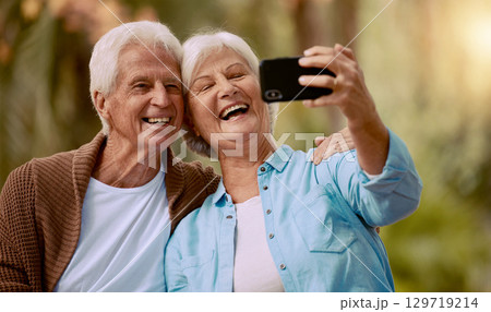 Senior couple and phone selfie and smile together outdoor during summer, social media and happy in park. Happy, Elderly man and woman take pictures on mobile smartphone for internet post or happiness Senior couple and phone selfie and smile together outdoor during summer, social media and happy in park. Happy, Elderly man and woman take pictures on mobile smartphone for internet post or happiness 129719214