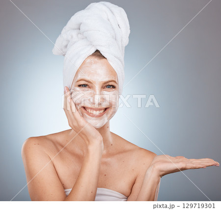 Woman portrait and face mask after a shower for skincare, beauty and health on a grey studio background. Skin care, mask for glowing skin on a female for cosmetic and dermatology wellness 129719301