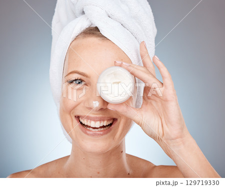 Woman, face or skincare cream in grooming routine, healthcare wellness or collagen treatment on gray studio background. Portrait, happy smile or beauty model or eye care product in Canada dermatology Woman, face or skincare cream in grooming routine, healthcare wellness or collagen treatment on gray studio background. Portrait, happy smile or beauty model or eye care product in Canada dermatology 129719330