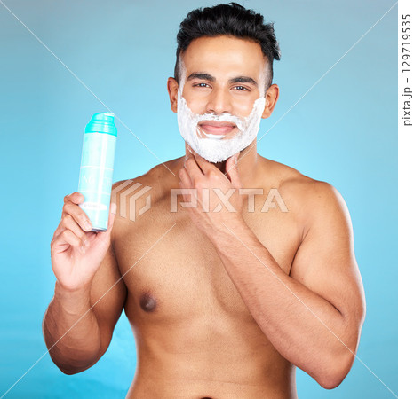 Man, facial beauty and shaving foam for beard grooming care portrait, hair removal or cosmetics hygiene in studio. Luxury skincare wellness, happy skincare treatment and shave face in blue background Man, facial beauty and shaving foam for beard grooming care portrait, hair removal or cosmetics hygiene in studio. Luxury skincare wellness, happy skincare treatment and shave face in blue background 129719535