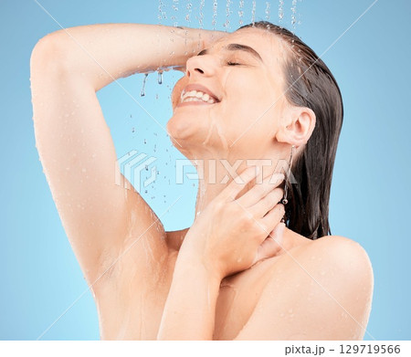 Skincare, shower and woman with water in studio on blue background for washing, cleaning and hygiene. Spa, hydration and girl with stream, drops and water splash for body care, wellness and health Skincare, shower and woman with water in studio on blue background for washing, cleaning and hygiene. Spa, hydration and girl with stream, drops and water splash for body care, wellness and health 129719566