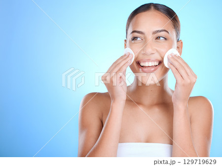 Skincare, face and woman with cotton pads, cosmetics and wellness on blue studio background. Makeup remover, female and Mexican girl with smile, natural beauty and confident for clear and smooth skin Skincare, face and woman with cotton pads, cosmetics and wellness on blue studio background. Makeup remover, female and Mexican girl with smile, natural beauty and confident for clear and smooth skin 129719629
