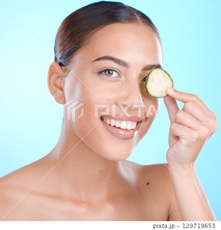 Face, cucumber and facial skincare, happy smile and vegan or healthy product marketing or advertising space. Happy model with vitamin c fruits for skin care glow, happiness and self care for skin 129719653