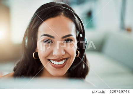 Call center, customer service and help desk agent looking friendly, happy and smiling while wearing a headset and working on a computer. Portrait of Cheerful sales employee, remote or virtual worker Call center, customer service and help desk agent looking friendly, happy and smiling while wearing a headset and working on a computer. Portrait of Cheerful sales employee, remote or virtual worker 129719748