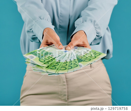 Money, investment and finance success of a businesswoman hands with cash, bank notes or wealth. Closeup showing person making large payment, spending her savings, financial growth or business profit 129719758