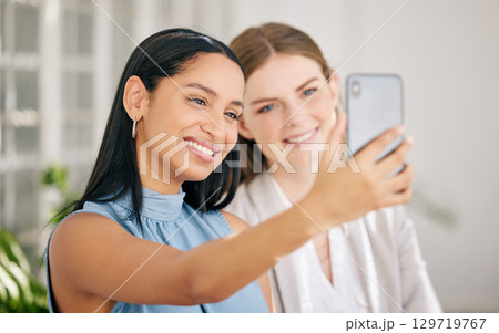 Business women taking team selfie for social media on phone as a happy, smile and success collaboration in a startup agency. Friends, diversity staff and creative worker with motivation in office 129719767