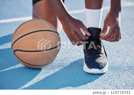 Fitness man on a court with a basketball for training, exercise and a workout by playing sports in athletic shoes. African athlete living a healthy, wellness and motivational lifestyle in summer Fitness man on a court with a basketball for training, exercise and a workout by playing sports in athletic shoes. African athlete living a healthy, wellness and motivational lifestyle in summer 129719781