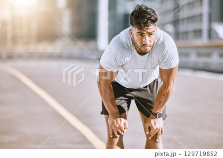 Man resting, after jogging and running in the city for fitness. Healthy, fit and alone runner catching his breath after a run in the morning. Training, cardio and relaxing after a workout in town. Man resting, after jogging and running in the city for fitness. Healthy, fit and alone runner catching his breath after a run in the morning. Training, cardio and relaxing after a workout in town. 129719852