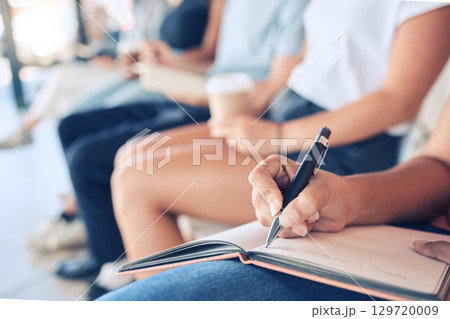 Audience, writing notes and notebook for learning knowledge at conference, meeting or workshop for training and education in convention room. Closeup, woman hands and goals with group of people Audience, writing notes and notebook for learning knowledge at conference, meeting or workshop for training and education in convention room. Closeup, woman hands and goals with group of people 129720009