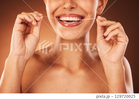 Teeth, zoom and woman with floss for dental cleaning, teeth whitening and healthy mouth protection in studio. Smile, wellness or hands of girl flossing with thread for natural tooth shine, self care Teeth, zoom and woman with floss for dental cleaning, teeth whitening and healthy mouth protection in studio. Smile, wellness or hands of girl flossing with thread for natural tooth shine, self care 129720025